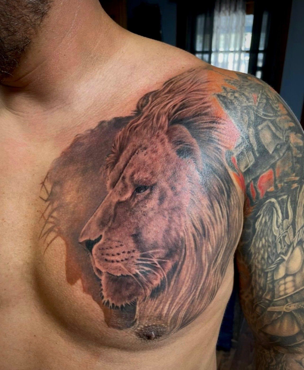 Detailed lion chest tattoo by an American Gypsy Tattoo artist